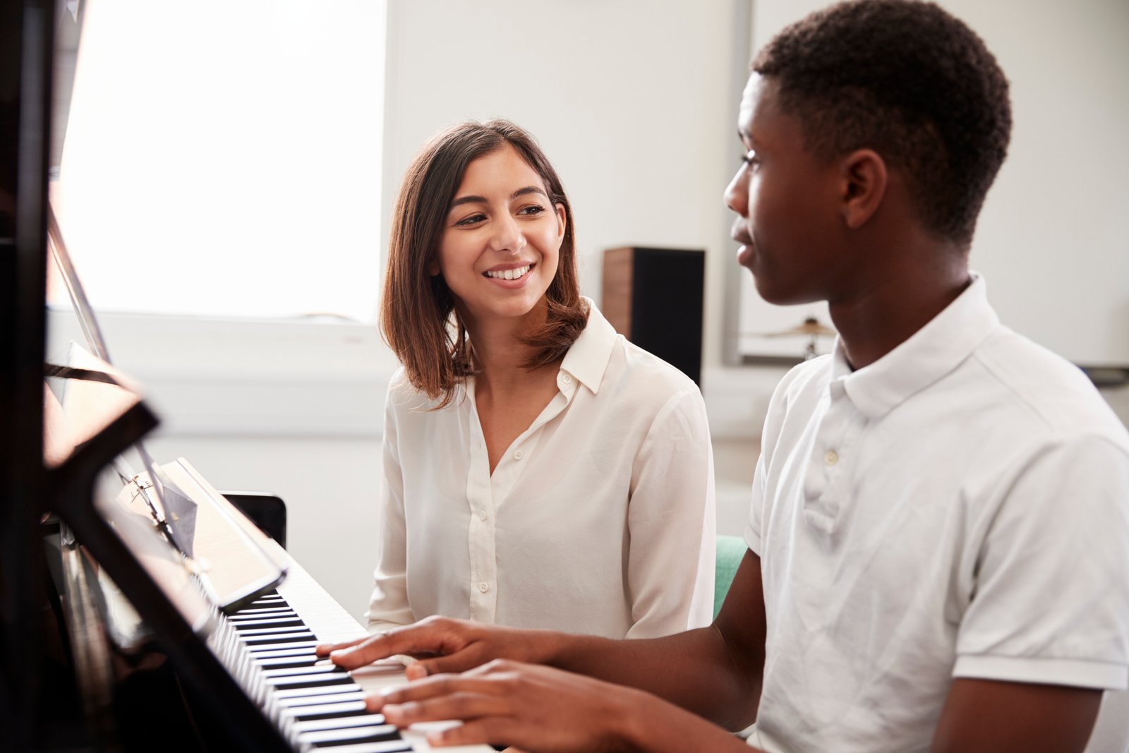 A young student at the piano during a lesson in Dublin