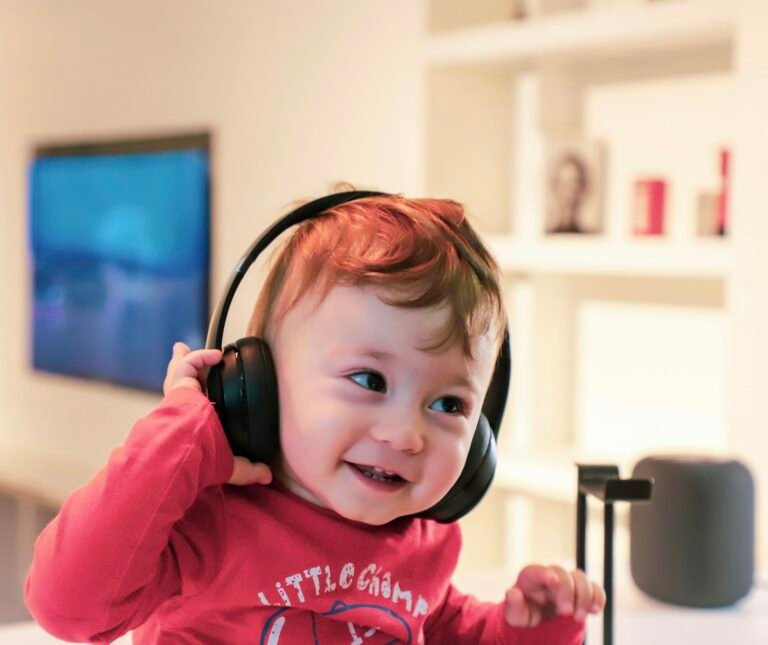 Smiling toddler wearing headphones and listening to music